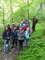 Kindergruppe unterwegs im Wald mit einem Ranger des Biosphärengebiets